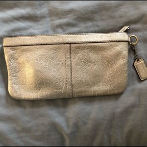 Metallic leather coach clutch